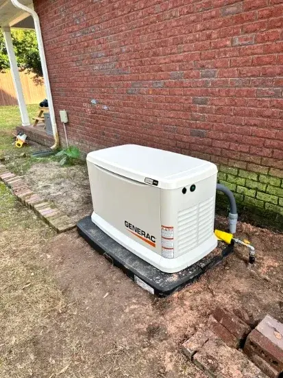 Generac standby generator installed beside a brick home in Gaston County, NC