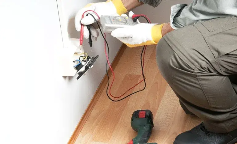 Roland Black electrician testing a home outlet for electrical faults in Gastonia, NC