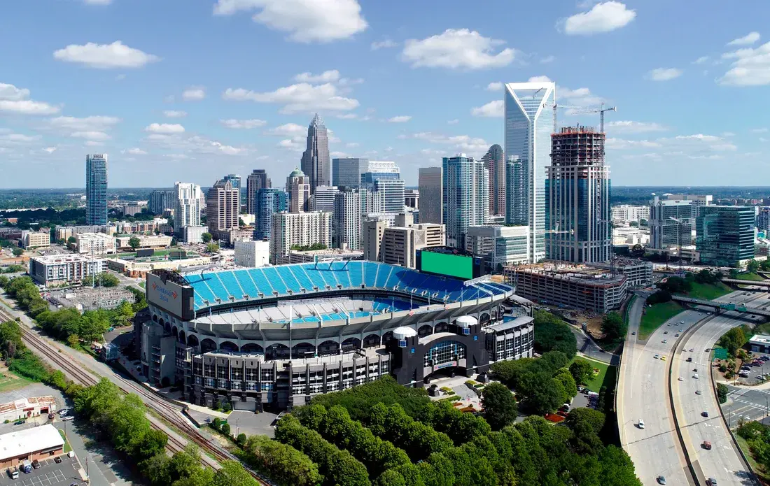 Aerial view of the Uptown Charlotte, NC skyline rising behind Bank of America Stadium Aerial view of the Uptown Charlotte, NC skyline rising behind Bank of America Stadium