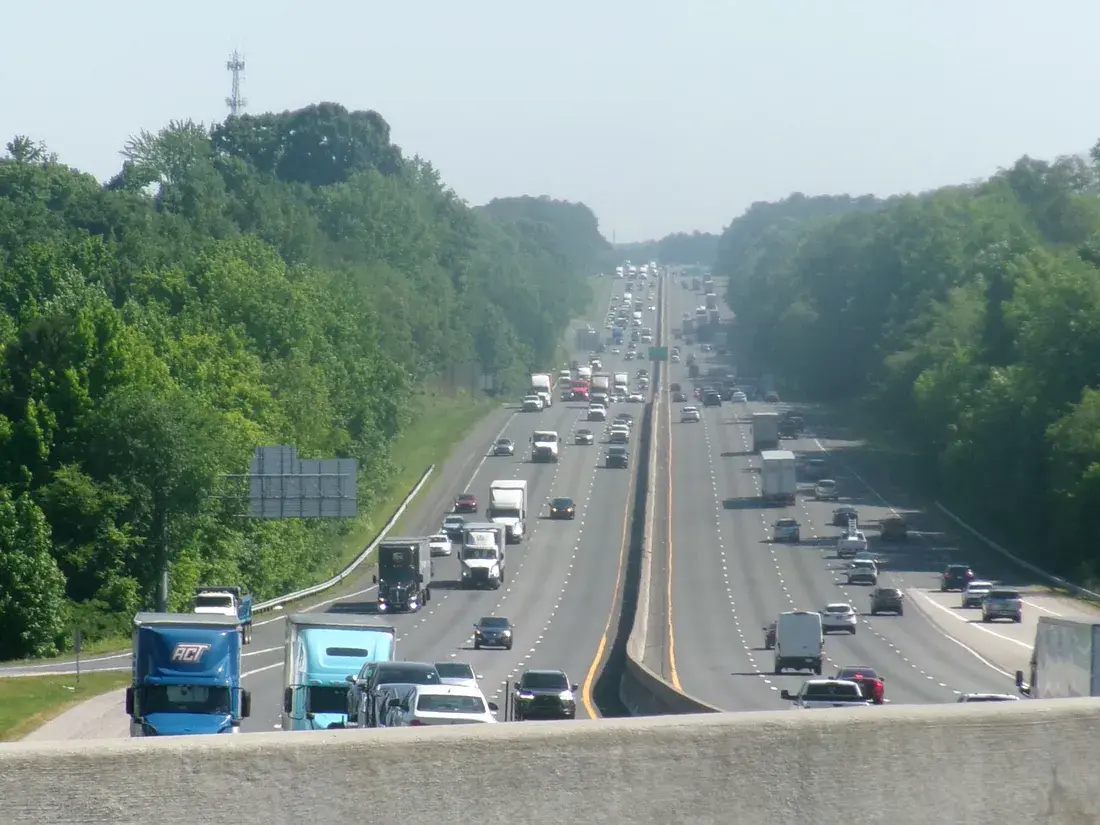 Traffic on I-77 northbound through the wooded edge of Fort Mill, SC Traffic on I-77 northbound through the wooded edge of Fort Mill, SC