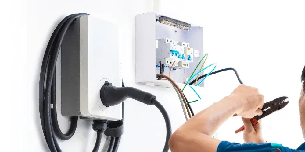 Electrician wiring a Level 2 EV charger to a dedicated circuit in Gastonia, NC Electrician wiring a Level 2 EV charger to a dedicated circuit in Gastonia, NC